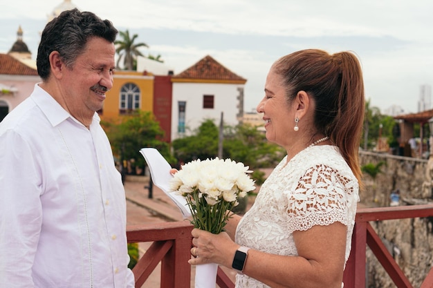 The groom looking and listening excitedly to his bride39s wedding vows