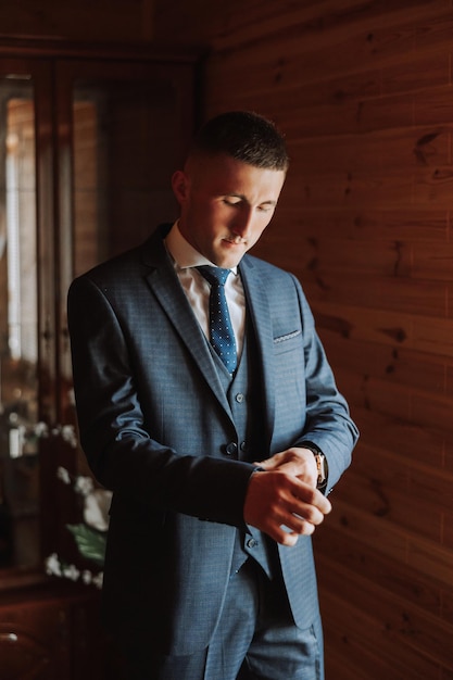 groom preparing for the wedding ceremony in the morning Grooms morning Preparation for the grooms morning The groom puts on a jacket The confident look of a mature man