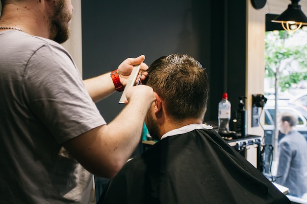 groom's haircut in the barbershop before the wedding, groom's haircut in the barbershop, close-up