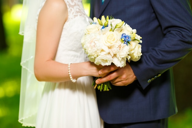 Groom in a suit and the bride in  white dress standing together