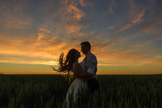 The groom tilted the bride and plays with her hair.