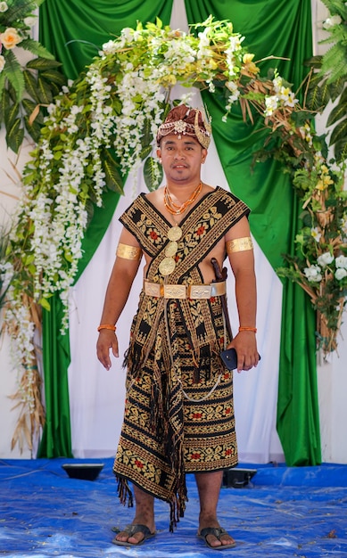 The groom wears sabu island traditional clothes during a traditional wedding