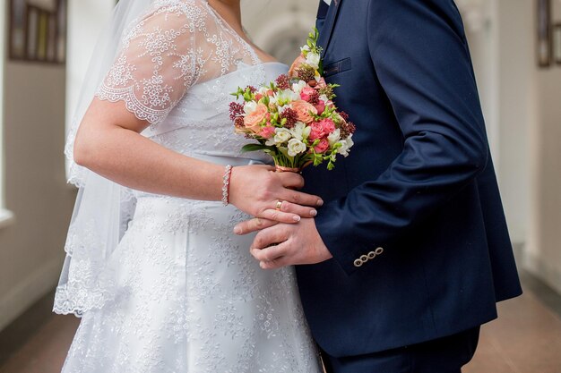 Groom with a bride and a bouquet of flowers