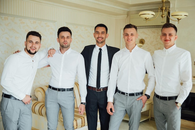 Groomsmen and groom posing on the wedding day.