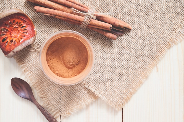 Ground cinnamon and cinnamon sticks tied 