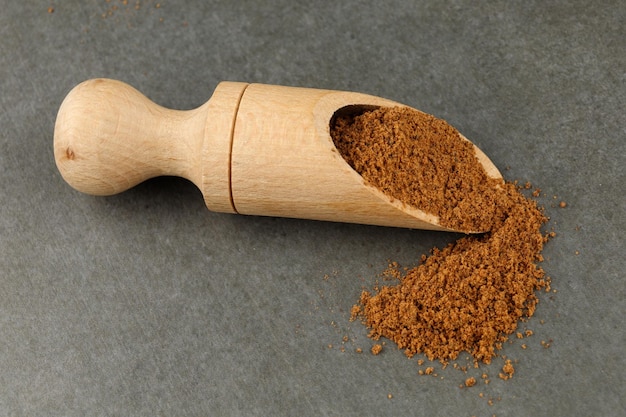 Ground nutmeg seasoning in a wooden scoop