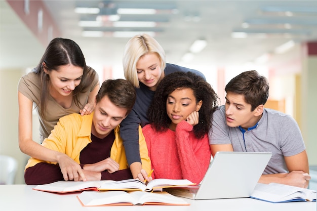 Grounp of five students studying together