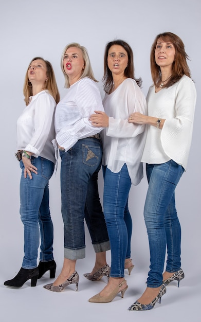 Photo group of 4 women, friends, middle-aged having fun in a photo session