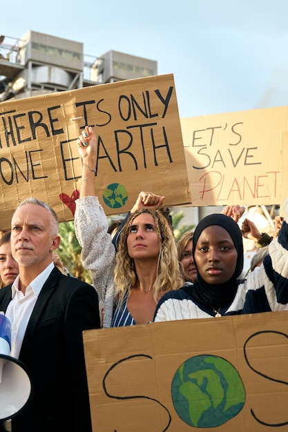 Photo group of activist people from different ages gathered to protest against factories and pollution