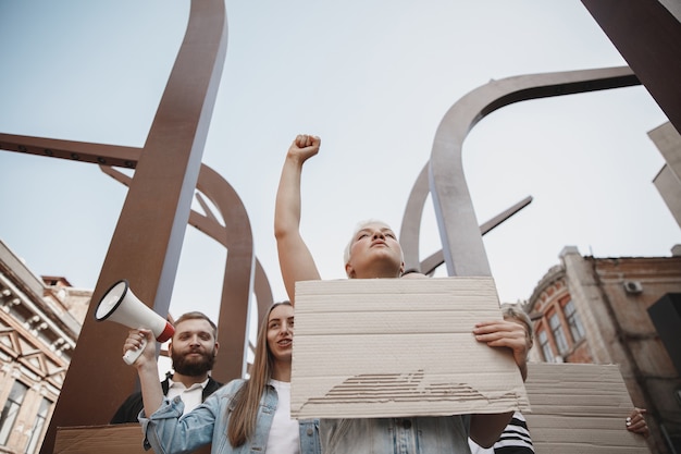 Photo group of activists giving slogans in a rally. men and women marching together in a protest