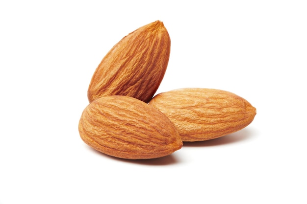 Group of almonds nuts isolated on white background. Nuts and seeds. Tasty and healthy organic snack. Almonds shelled nuts closeup view.