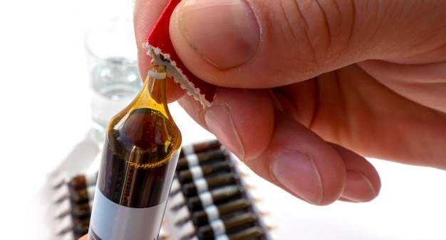 Group of ampoules with a transparent medicine in medical laboratory lot of ampoules on light background