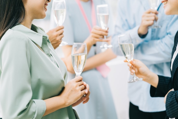 Group Asian business people are having a toast together and chatting at a company party