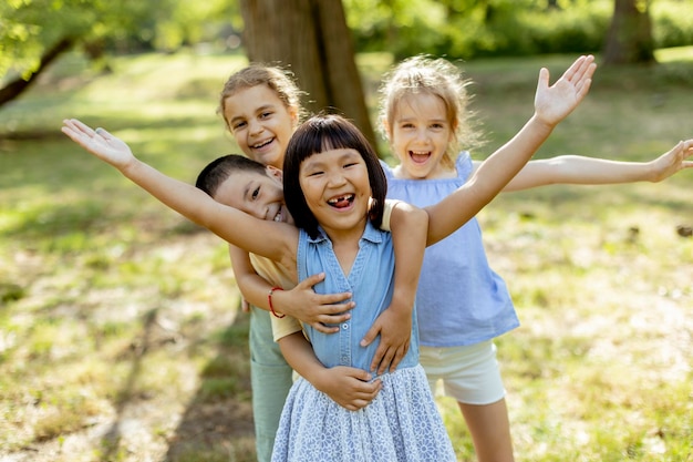 Group of asian and caucasian kids having fun in the park