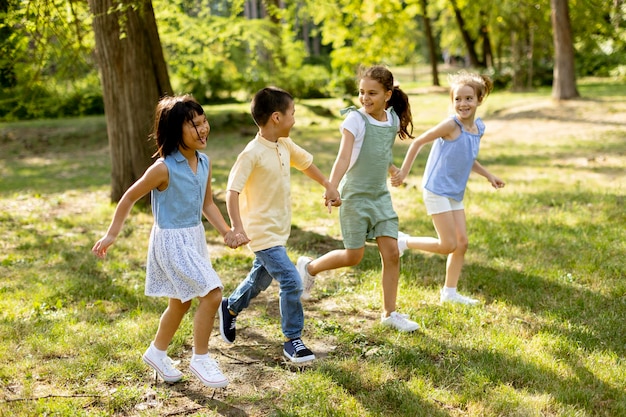 Group of asian and caucasian kids having fun in the park