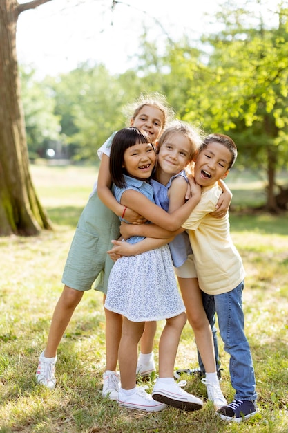 Group of asian and caucasian kids having fun in the park