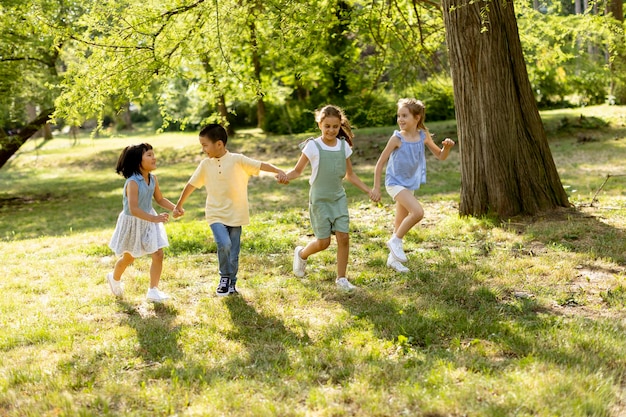 Group of asian and caucasian kids having fun in the park