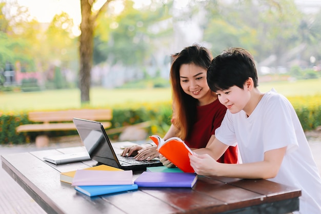 Group of asian young students are searching for data on the Internet to do homework