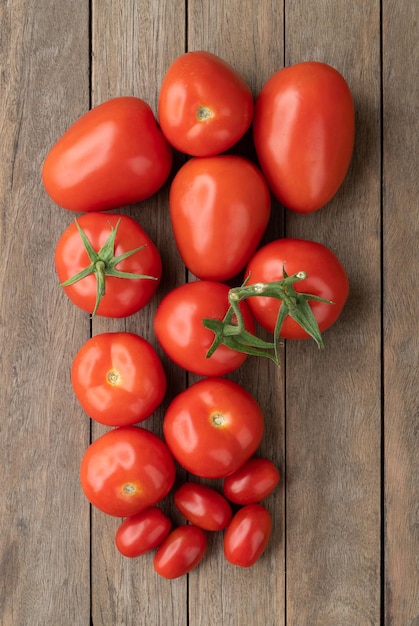 A group of assorted tomatoes over wooden table