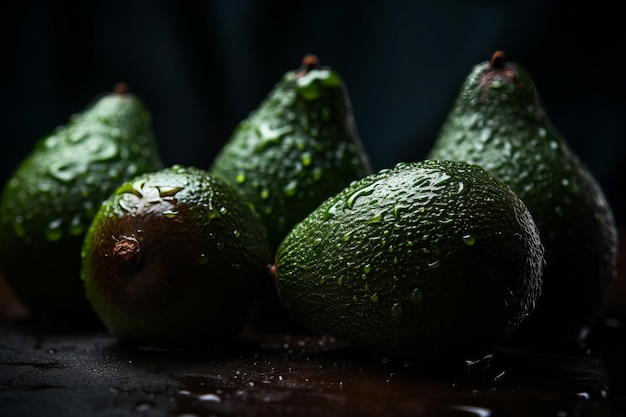 A group of avocados on a table with water droplets on them.