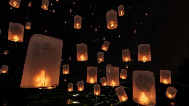 A group of beautiful sky lanterns in the dark sky at night Chinese flying lantern Memorial Day