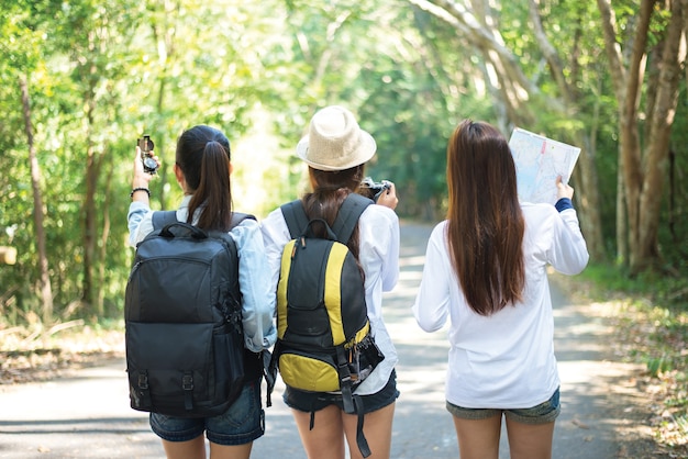 Group of beautiful young women walking in the forest, enjoying vacation