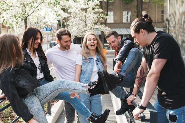 Group of best friends are having fun on a street. Young people happy to see each other during a meeting.