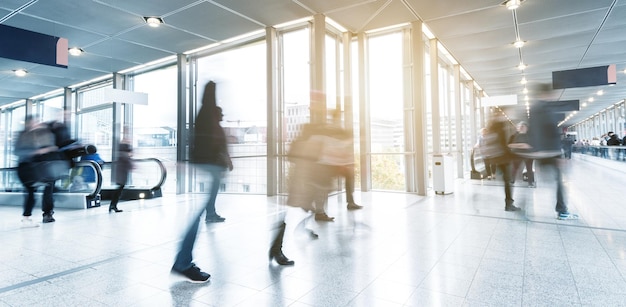 group of Blurred business people goes along a corridor