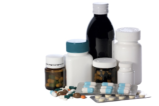 Group of bottles and with tablets and capsules and tablets in bulk