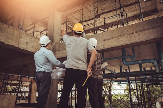 Group business man construction site engineer, effect Vintage sun flare.