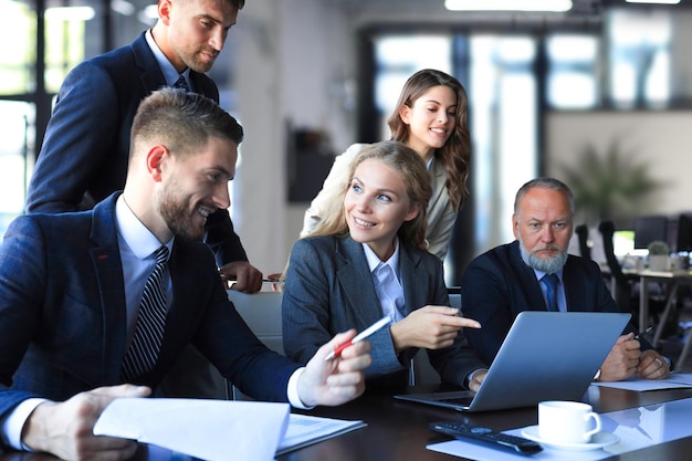 Group of business partners discussing ideas and planning work in office