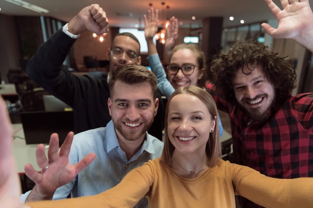 Group of business people during break from the work taking selfie picture while enjoying free time i