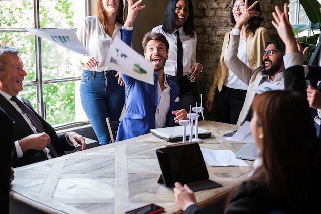 Group of business people celebrate the success of the meeting