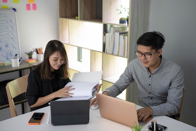 Group of business people discussing financial report together in office