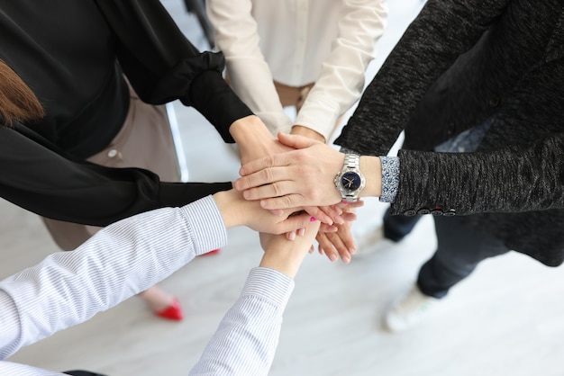 Photo group of business people folding many hands together closeup