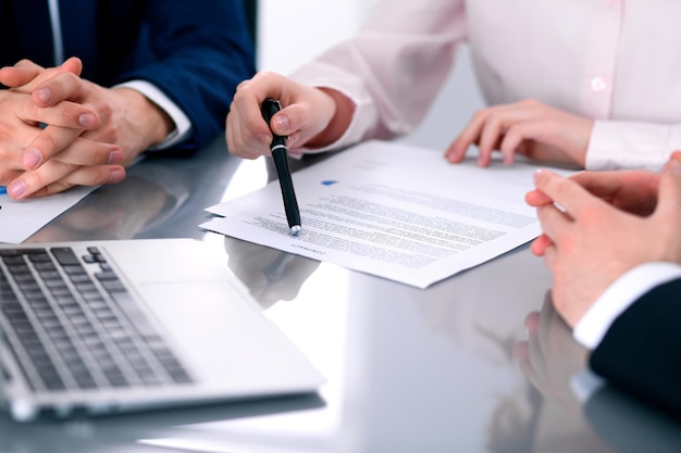 Group of business people and lawyers discussing contract papers