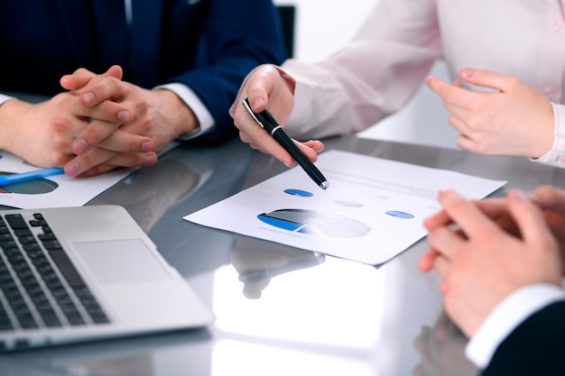 Group of business people at meeting discussing financial results