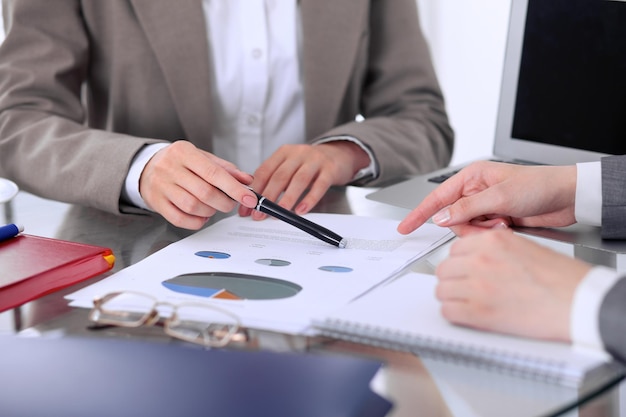 Group of business people at meeting discussing financial results