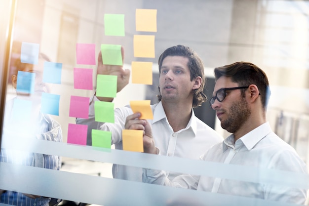 Group of business people sharing ideas in modern office