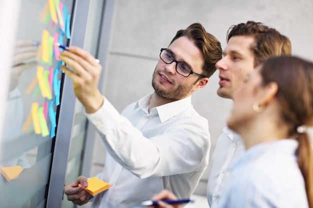 Group of business people sharing ideas in modern office