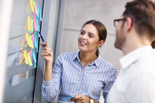 Group of business people sharing ideas in modern office