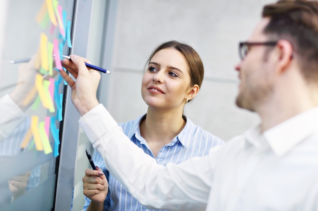 Group of business people sharing ideas in modern office