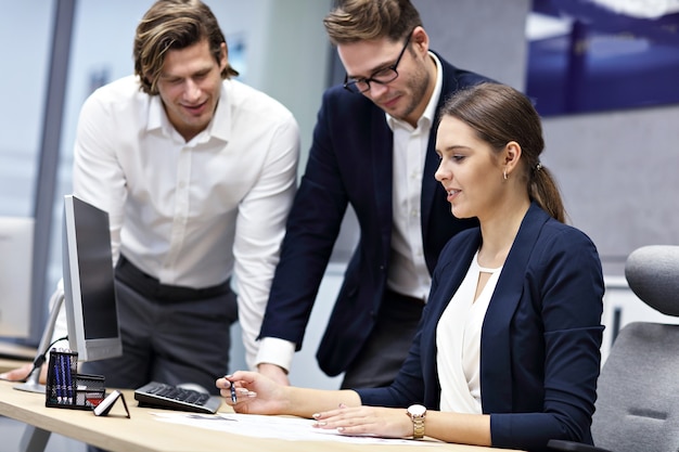 Group of business people sharing ideas in modern office