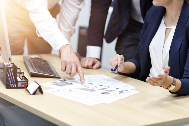 Group of business people sharing ideas in modern office