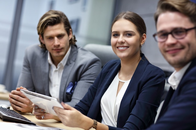 Group of business people sharing ideas in modern office