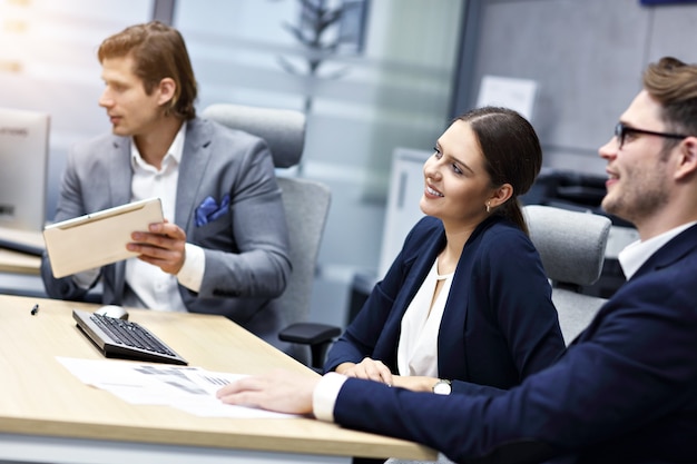 Group of business people sharing ideas in modern office