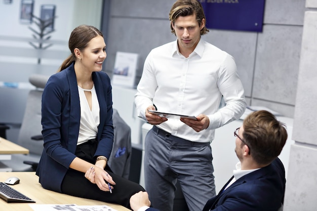 Group of business people sharing ideas in modern office