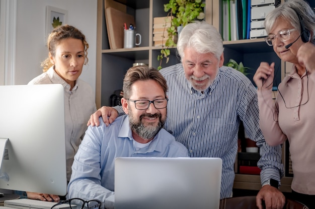 Group of business people working and communicating looking at online development e-commerce project