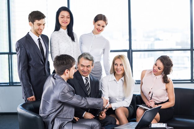 A group of businessmen discussing the policy of the company in the office.