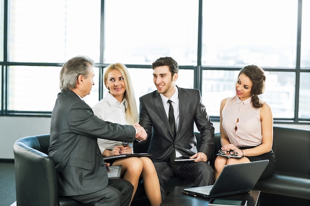 A group of businessmen discussing the policy of the company in the office.